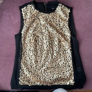 No sleeves, golden sequins on the front. Back zipper. Sheer back.